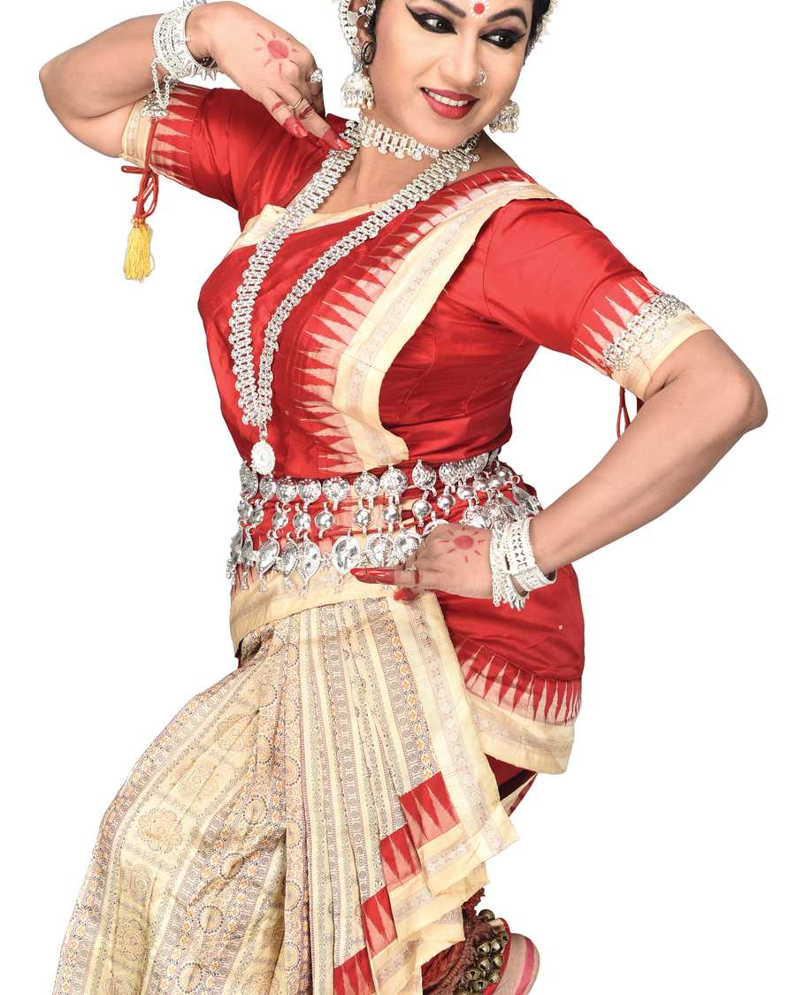 Shubhada Varadkar in a red blouse and cream Odissi skirt, hand at her waist.