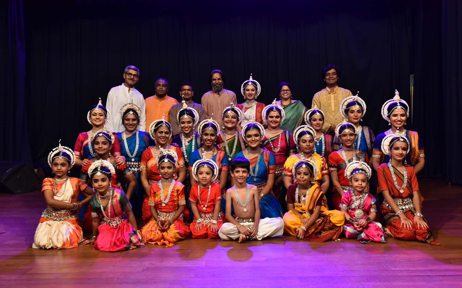 Shubhada Varadkar with her students and musicians on stage in costume.